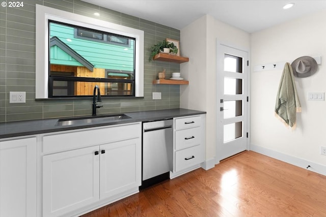 kitchen featuring sink, a wealth of natural light, stainless steel dishwasher, and white cabinets