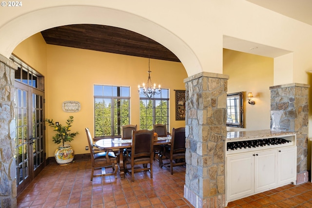 4974 W 44th Ave, Eugene, OR 97405 - dining room with arched walkways, a chandelier, a towering ceiling, and wood ceiling