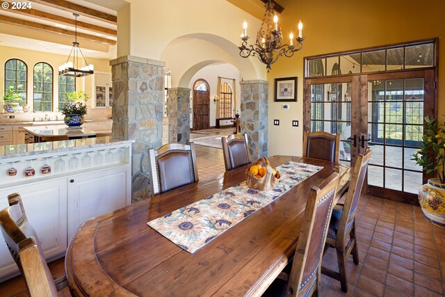 4974 W 44th Ave, Eugene, OR 97405 - dining room with arched walkways, french doors, a chandelier, and beamed ceiling