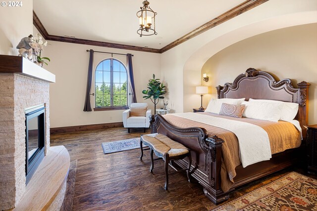 4974 W 44th Ave, Eugene, OR 97405 - bedroom featuring wood finished floors, ornamental molding, baseboards, a stone fireplace, and arched walkways