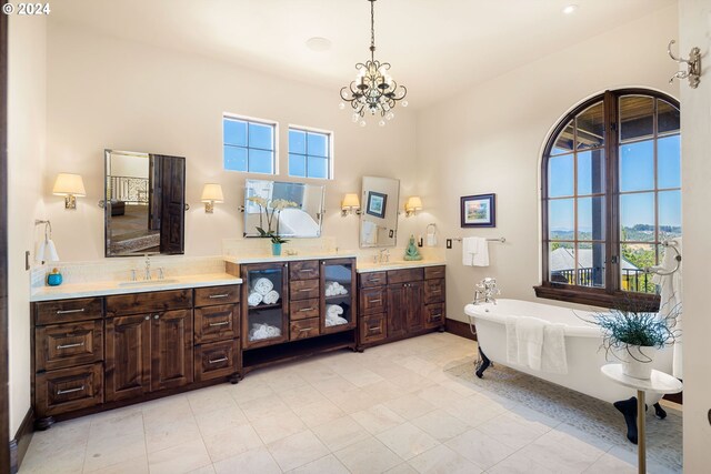 4974 W 44th Ave, Eugene, OR 97405 - full bathroom with a freestanding bath, two vanities, a chandelier, and baseboards