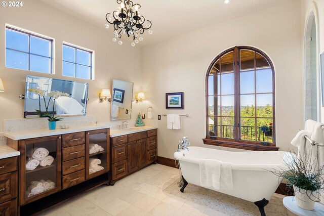 4974 W 44th Ave, Eugene, OR 97405 - bathroom featuring double vanity, a soaking tub, a chandelier, and baseboards