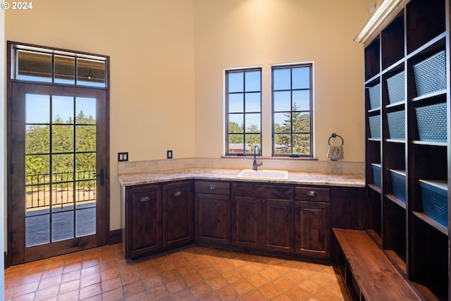 4974 W 44th Ave, Eugene, OR 97405 - kitchen with a sink, dark brown cabinets, a high ceiling, and light stone counters