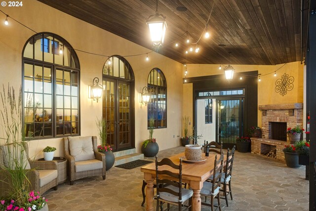 4974 W 44th Ave, Eugene, OR 97405 - dining area with stone flooring, wood ceiling, an outdoor brick fireplace, and high vaulted ceiling