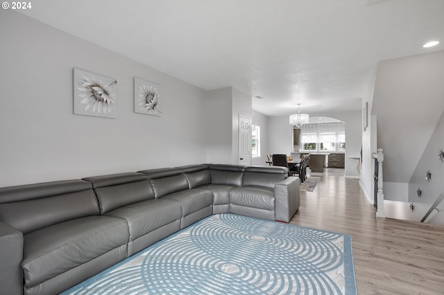 living room featuring a chandelier and light hardwood / wood-style floors