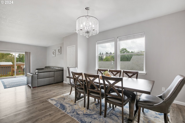 dining room featuring a notable chandelier and dark wood-type flooring