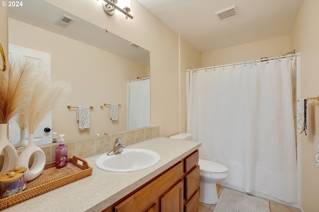 bathroom with tile patterned floors, vanity, and toilet