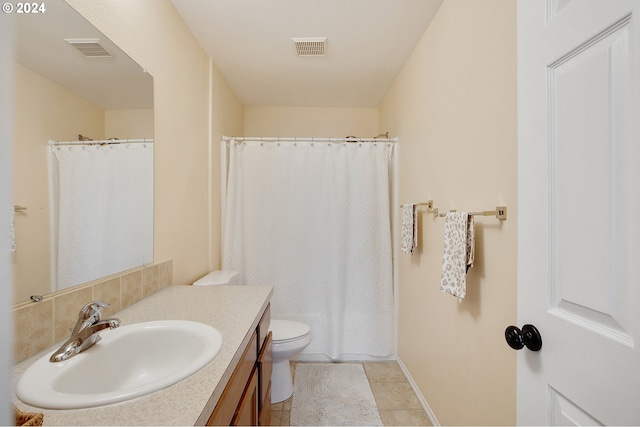 bathroom featuring tile patterned floors, vanity, and toilet