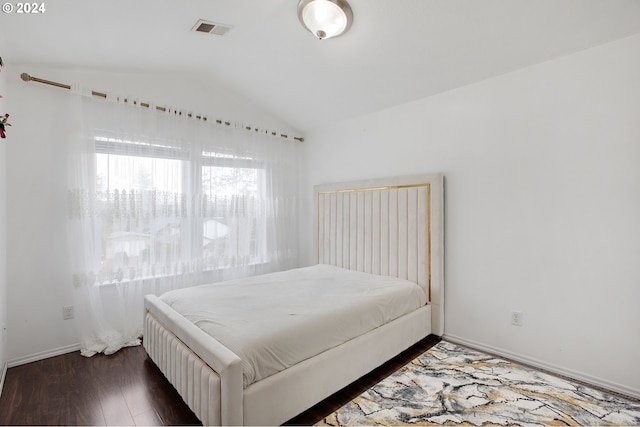 bedroom featuring dark hardwood / wood-style floors and lofted ceiling