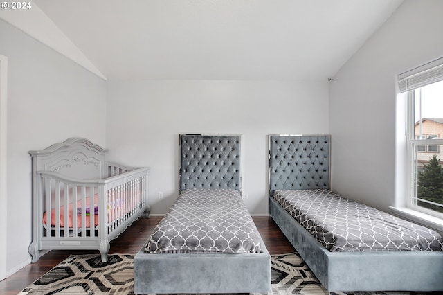 bedroom with dark hardwood / wood-style flooring and lofted ceiling