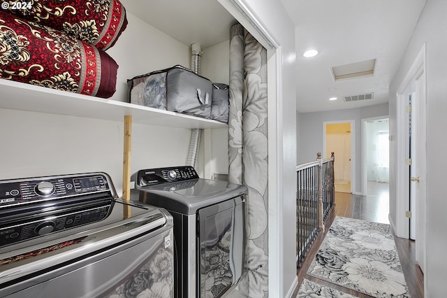 laundry room featuring washer and clothes dryer and hardwood / wood-style flooring