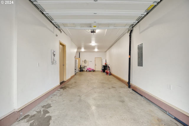 garage with electric panel, water heater, and a garage door opener