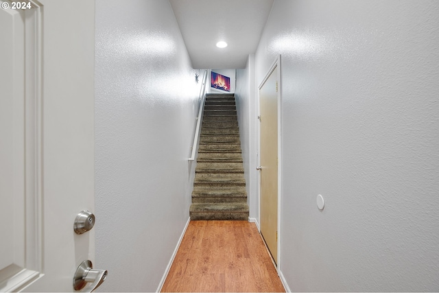 stairs with hardwood / wood-style flooring