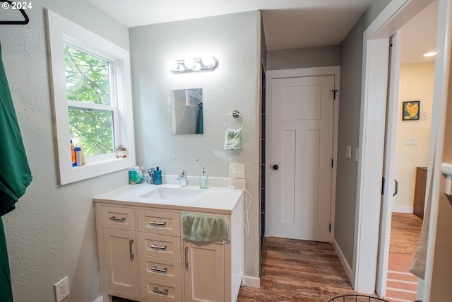 bathroom with hardwood / wood-style floors and vanity