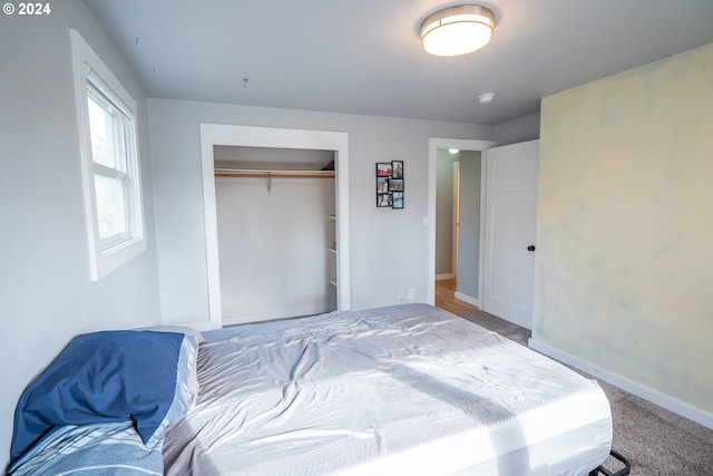 carpeted bedroom with a closet