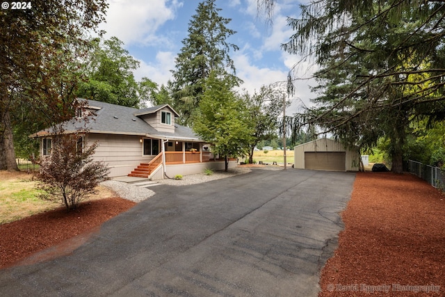 view of front of property featuring an outdoor structure and a garage