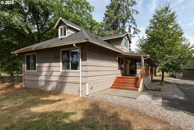 view of side of property featuring a porch