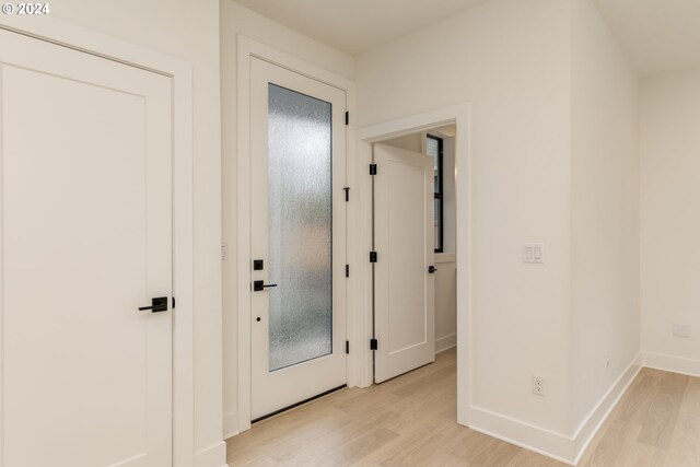 unfurnished bedroom with light colored carpet and a closet