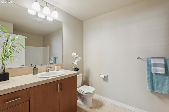 bathroom with tile patterned flooring, vanity, and toilet