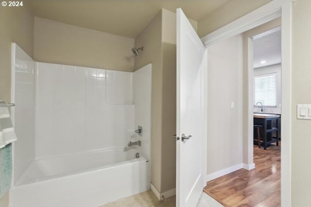 bathroom featuring hardwood / wood-style floors and shower / bath combination