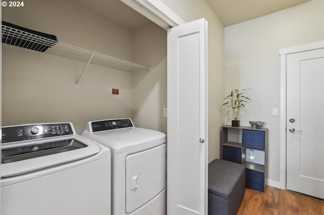 laundry room with dark hardwood / wood-style flooring and independent washer and dryer