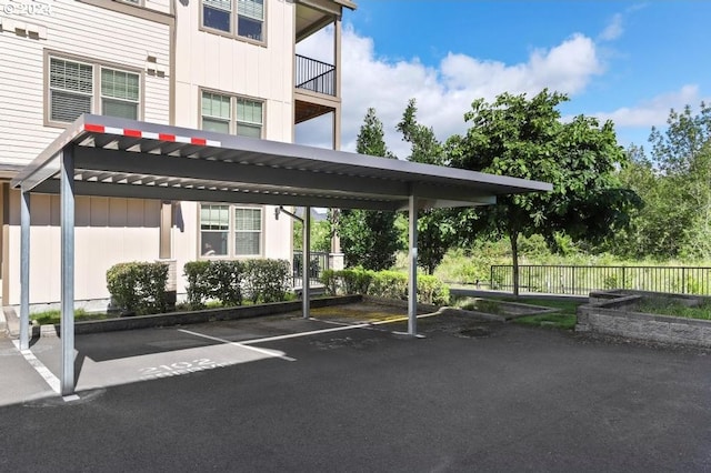 view of parking / parking lot featuring a carport