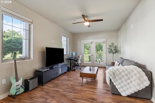 living room with dark hardwood / wood-style flooring, a wealth of natural light, french doors, and ceiling fan