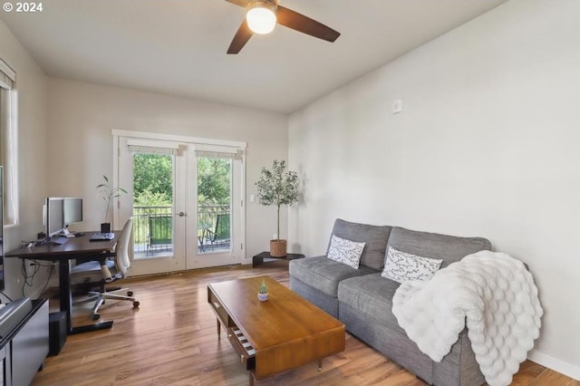 living room with hardwood / wood-style floors, ceiling fan, and french doors