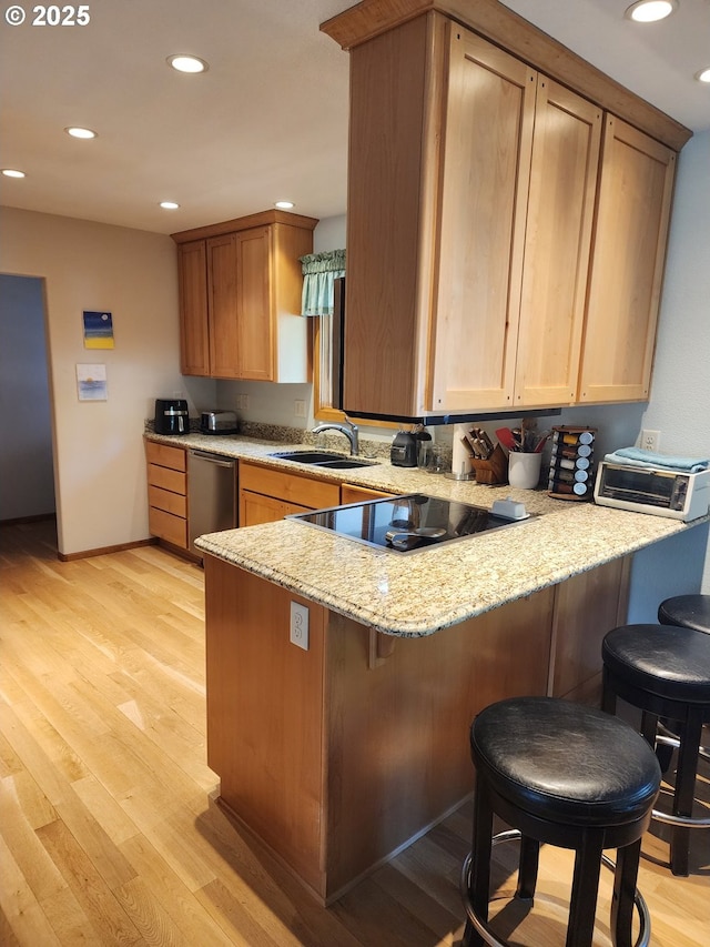3413 Wild River Dr, Roseburg, OR 97470 - kitchen with a peninsula, a sink, dishwasher, light stone countertops, and light wood-style flooring