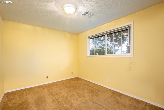 unfurnished room featuring carpet floors and a textured ceiling