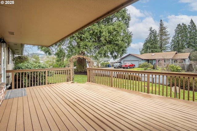 wooden deck featuring a yard