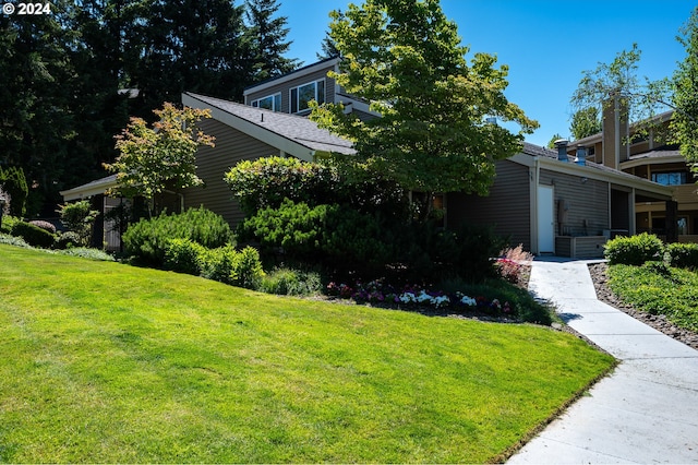 view of property exterior with a lawn