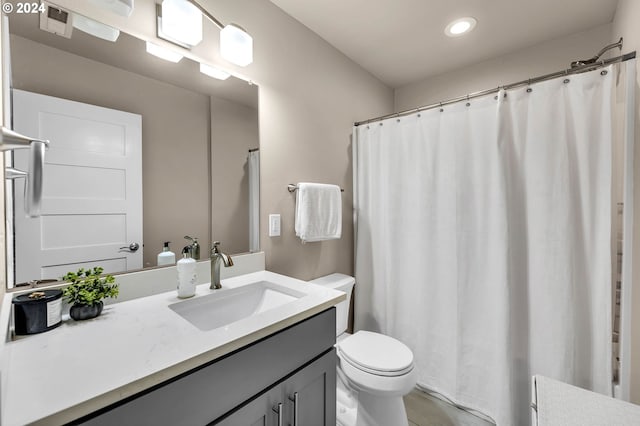 bathroom with toilet and vanity