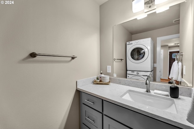 bathroom featuring vanity and stacked washer and clothes dryer