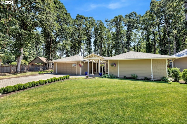 single story home featuring a garage and a front yard