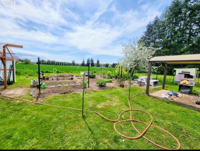 view of property's community with a yard and a rural view