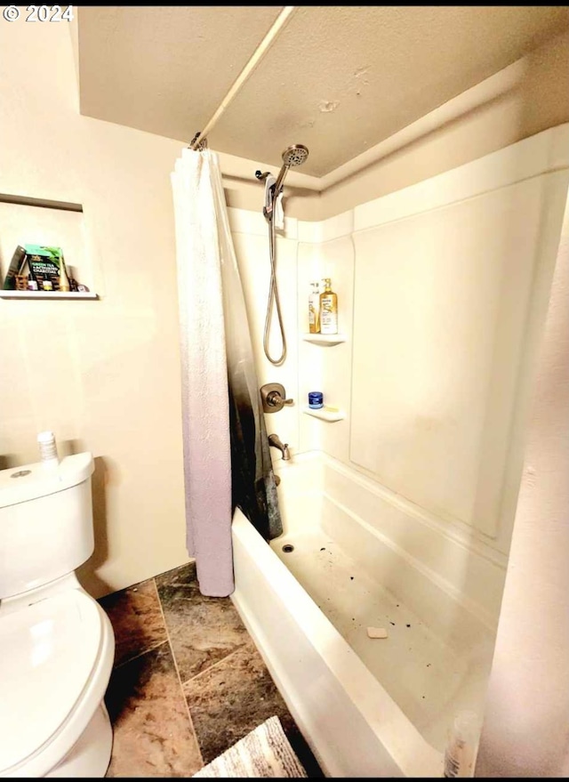 full bathroom with shower / bath combo with shower curtain and toilet