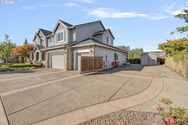 view of front of home with a garage and a storage shed