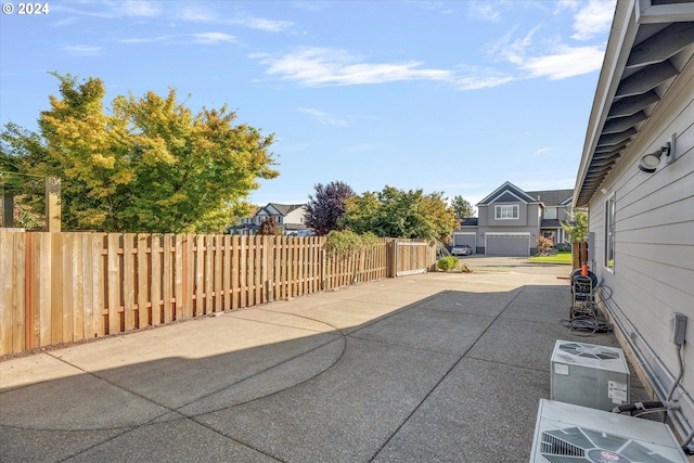 view of patio / terrace with a garage and central AC unit