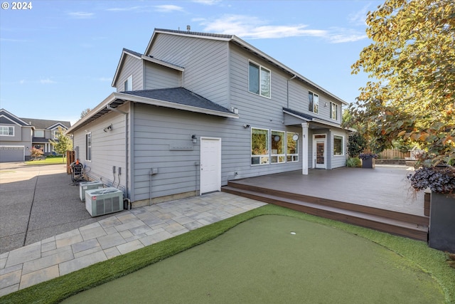 rear view of house featuring a wooden deck and central air condition unit