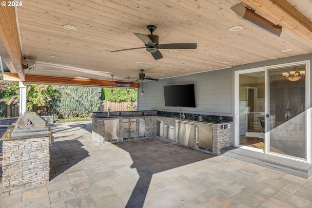 view of patio with sink, ceiling fan, and an outdoor kitchen