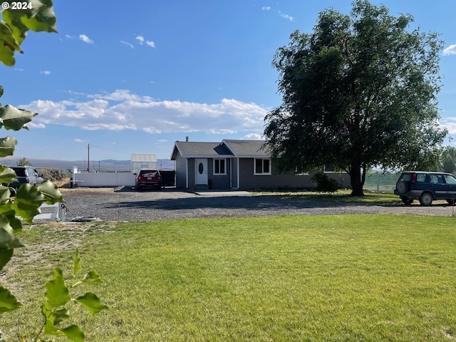 view of yard featuring gravel driveway and fence