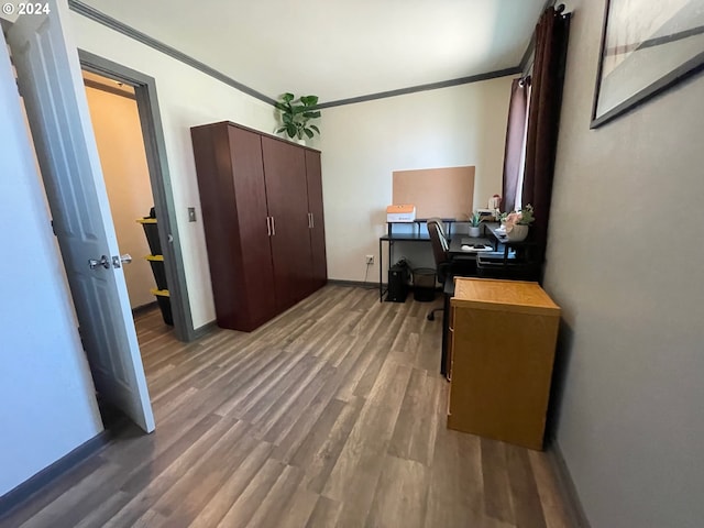 office space featuring dark wood-style floors, baseboards, and ornamental molding