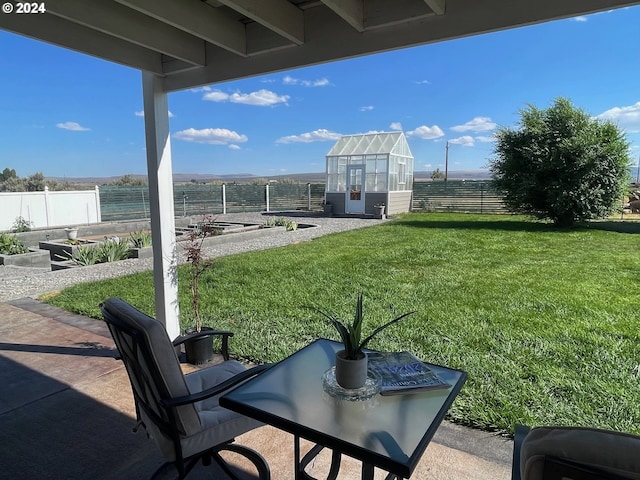 view of patio featuring a fenced backyard, a vegetable garden, an outdoor structure, and an exterior structure