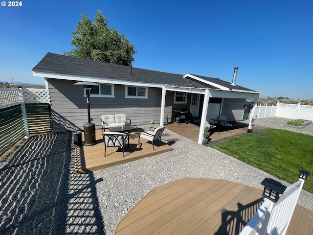 rear view of house featuring a fenced backyard, outdoor lounge area, and a wooden deck