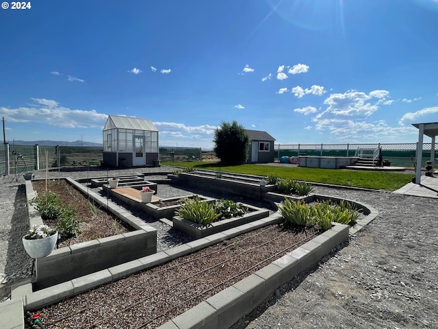 surrounding community featuring a storage shed, a vegetable garden, an outbuilding, a yard, and an exterior structure