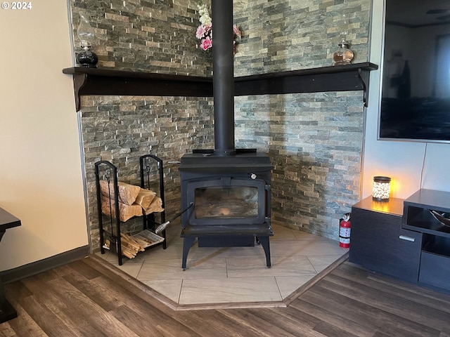 room details featuring wood finished floors and a wood stove