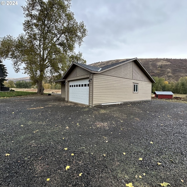 81890 S Fork Walla Walla Riv Rd, Milton-Freewater, OR 97862 - view of property exterior with an attached garage, asphalt driveway, and an outbuilding