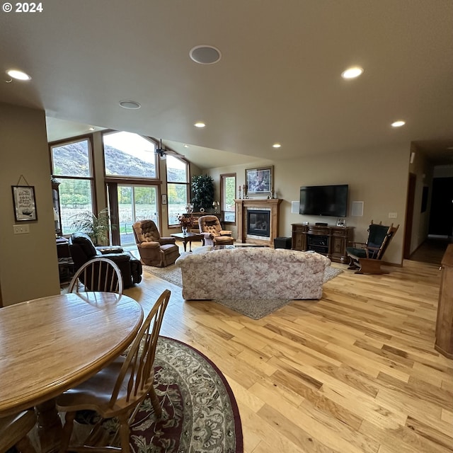 dining space featuring light wood-type flooring, ceiling fan, and lofted ceiling