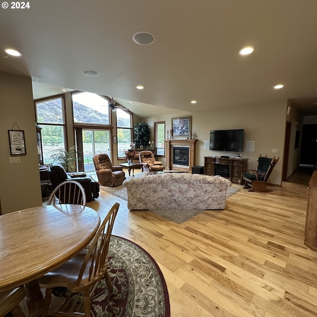 81890 S Fork Walla Walla Riv Rd, Milton-Freewater, OR 97862 - dining space featuring light wood-type flooring, a glass covered fireplace, vaulted ceiling, and recessed lighting